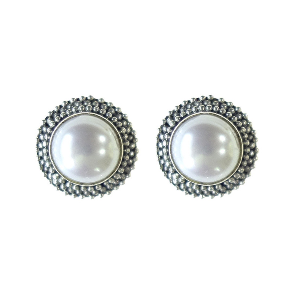 White pearl stud earrings with decorative silver beaded border