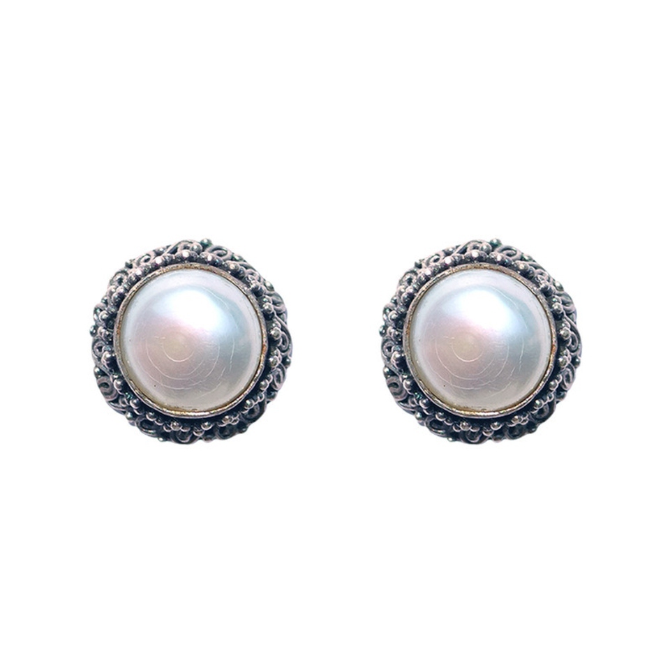 White pearl stud earrings with ornate silver beaded border