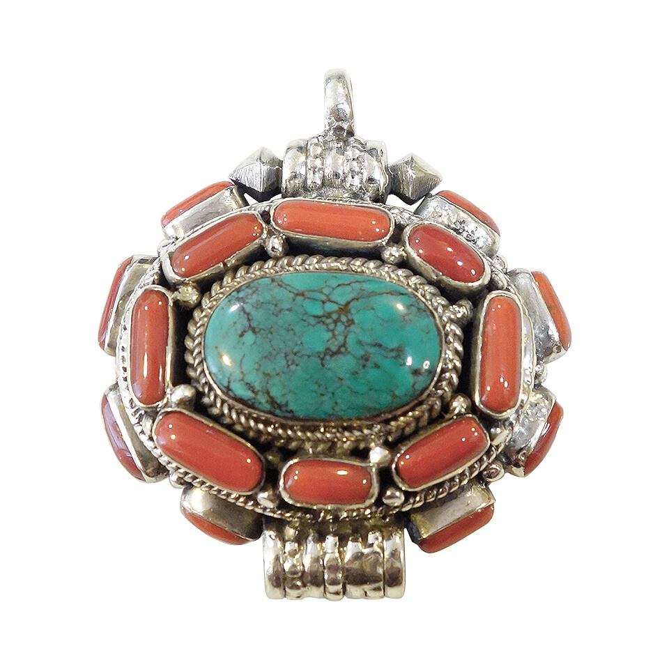 Tibetan pendant with stabilized turquoise center and coral inlay