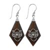 Handmade tribal diamond-shaped wooden earrings with silver swirl design