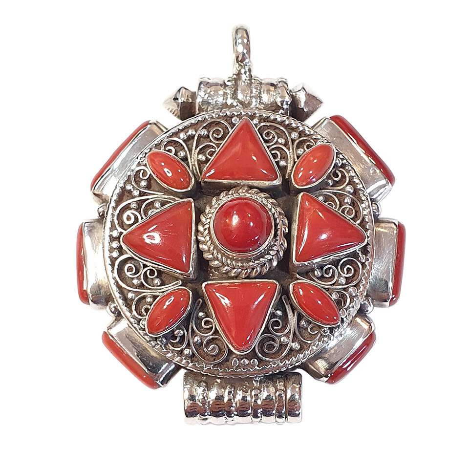 Tibetan round pendant with coral inlay and intricate silver filigree design