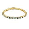 Gold-plated tennis bracelet with oval-cut blue topaz gemstones