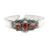Ornate sterling silver cuff bracelet with three red coral stones and intricate scrollwork detailing