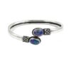 Sterling silver open bangle with dual oval opal gemstones and ornate detailing