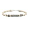 Beige braided leather bracelet with ornate silver tube beads.