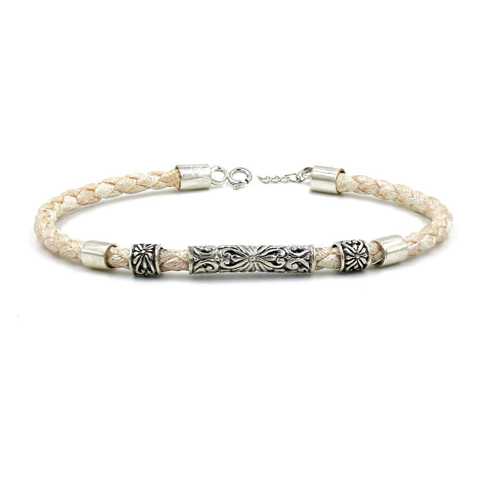 Beige braided leather bracelet with ornate silver tube beads.