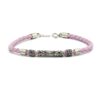 Pink braided leather bracelet with ornate silver tube beads.