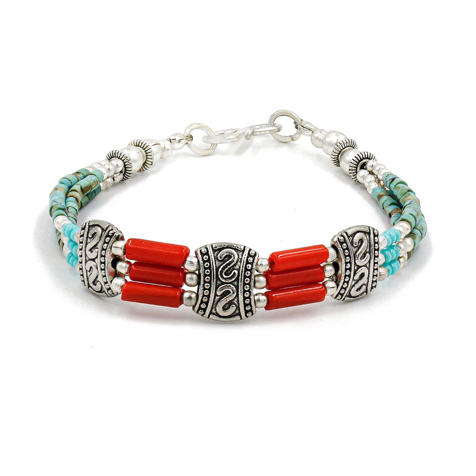 Handmade Tibetan silver bracelet with turquoise beads and coral tubes.