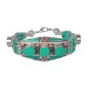Handcrafted bracelet with green turquoise inlay and intricate silver accents