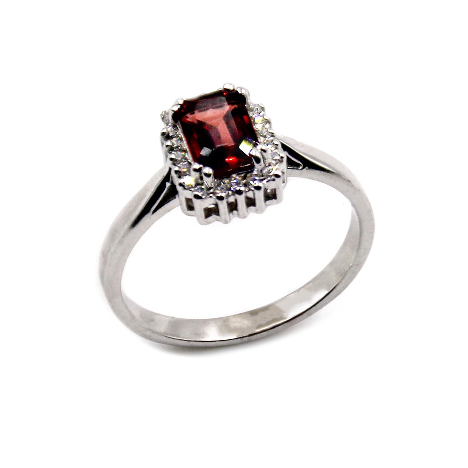 Sterling silver ring with rectangular-cut Garnet gemstone and a halo of sparkling white stones