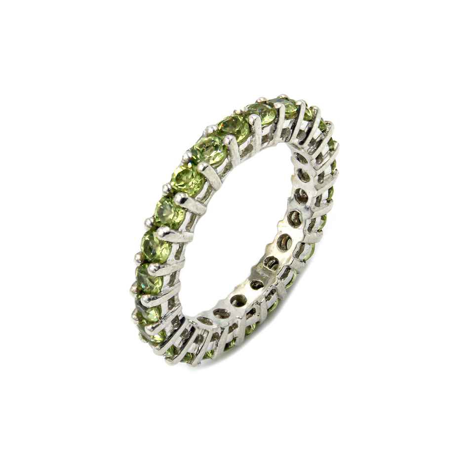 Sterling silver eternity ring with round-cut Peridot gemstones in prong setting