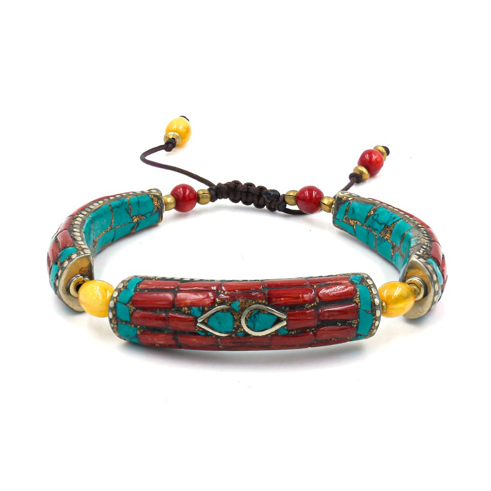 Handcrafted bracelet with red coral and turquoise inlay, yellow beads, and adjustable cord closure