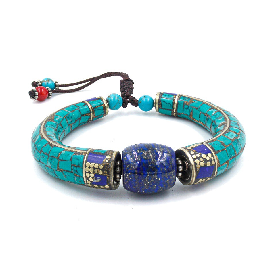 Handcrafted bracelet with turquoise inlay, central lapis lazuli bead, and adjustable cord closure