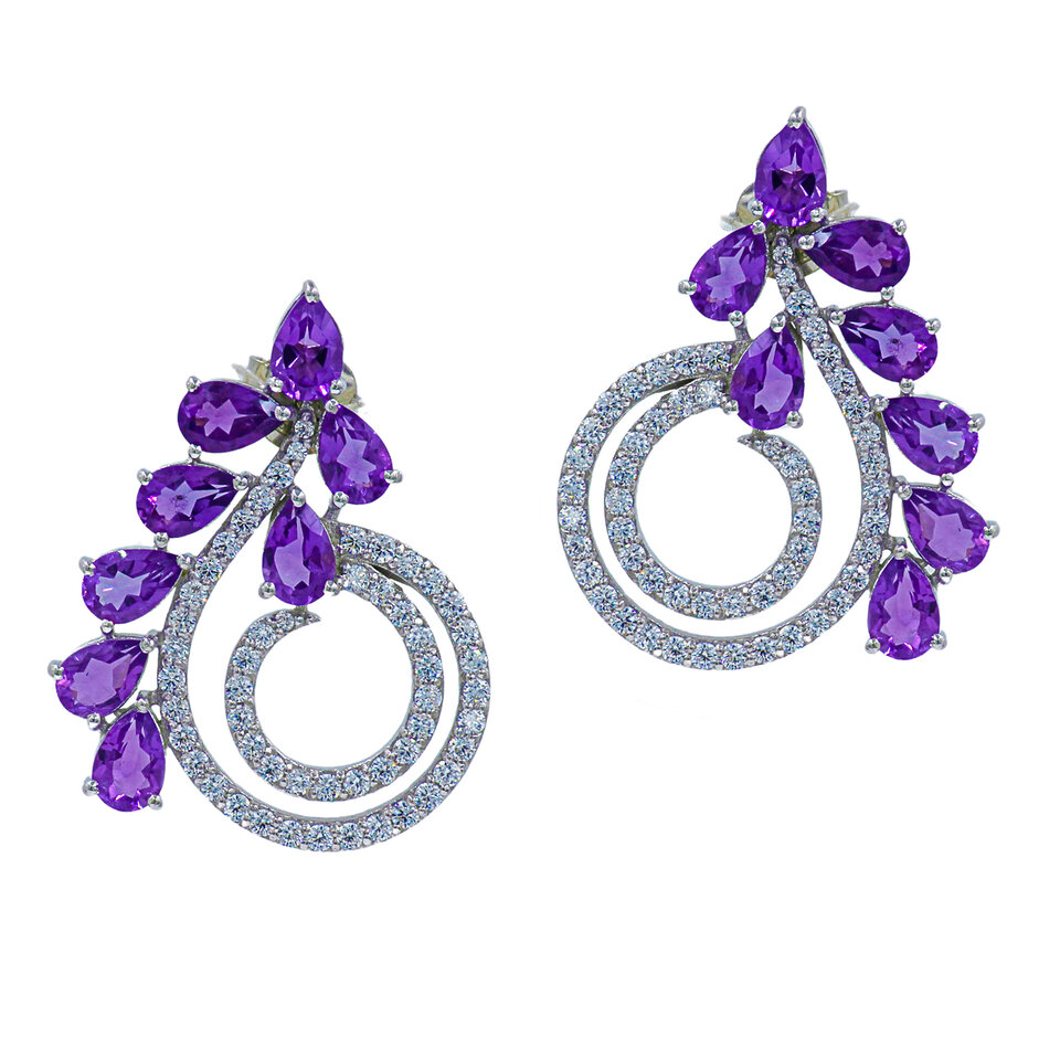 Silver spiral earrings with purple amethyst stones.