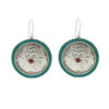 Handcrafted round silver earrings with turquoise border and red stone center.